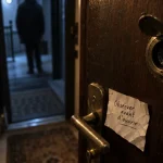 Judas sur porte installé sur un vantail en bois